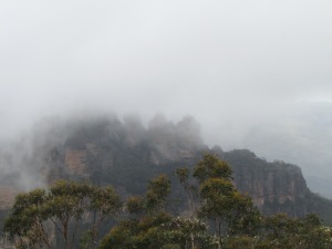 View of the Three Sisters appearing through the mist
